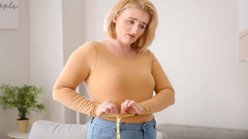 A worried woman over weight gain