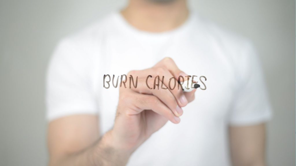 Burn calories written on glass by a man